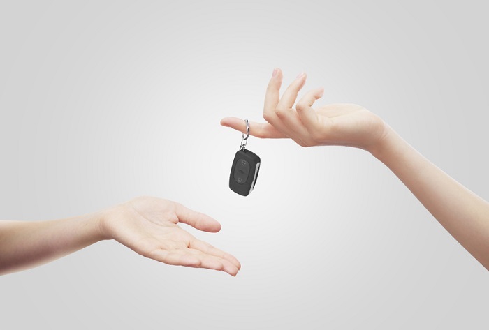 Hands Exchanging Car Keys