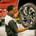 Lexus technician mounting a tire