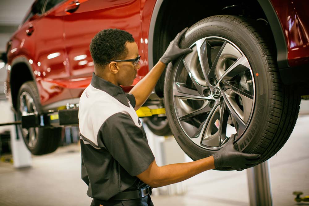 Lexus technician mounting a tire