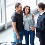 car dealer meeting with a couple