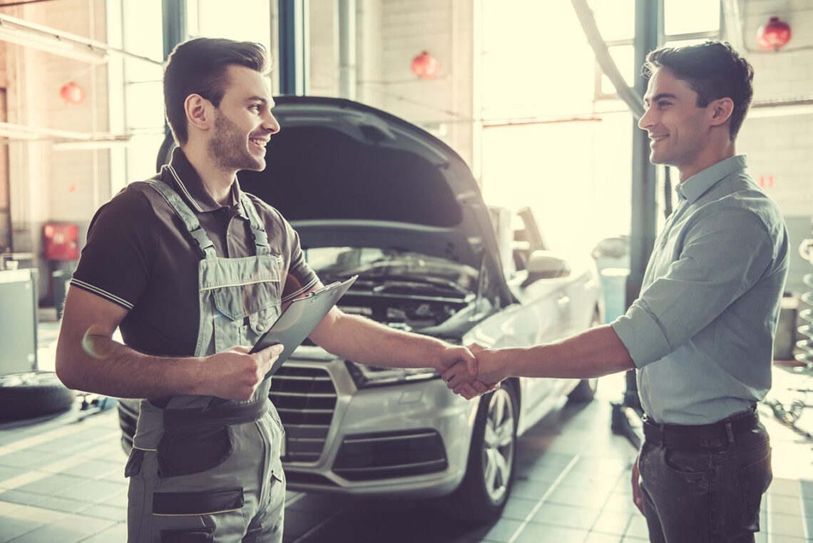 mechanic shaking hands with a customer