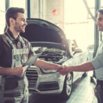 mechanic shaking hands with a customer