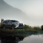Lexus GX with a camper and two people